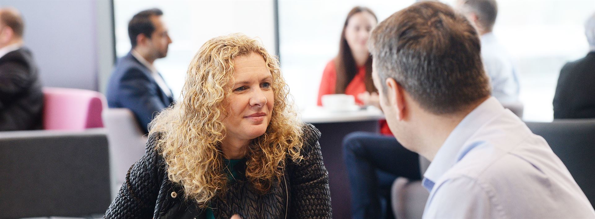 A business team reviewing product designs at a workshop table