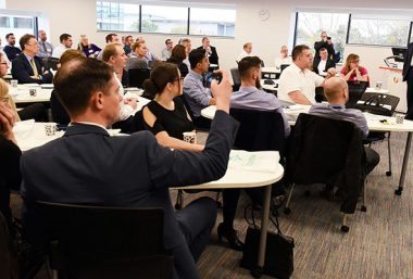 Industry leaders attending a digital transformation event