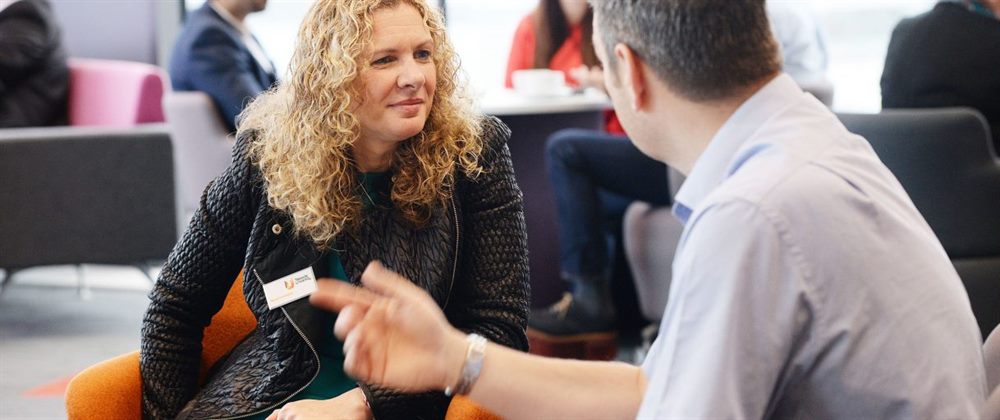 A graduate working alongside colleagues in a business office