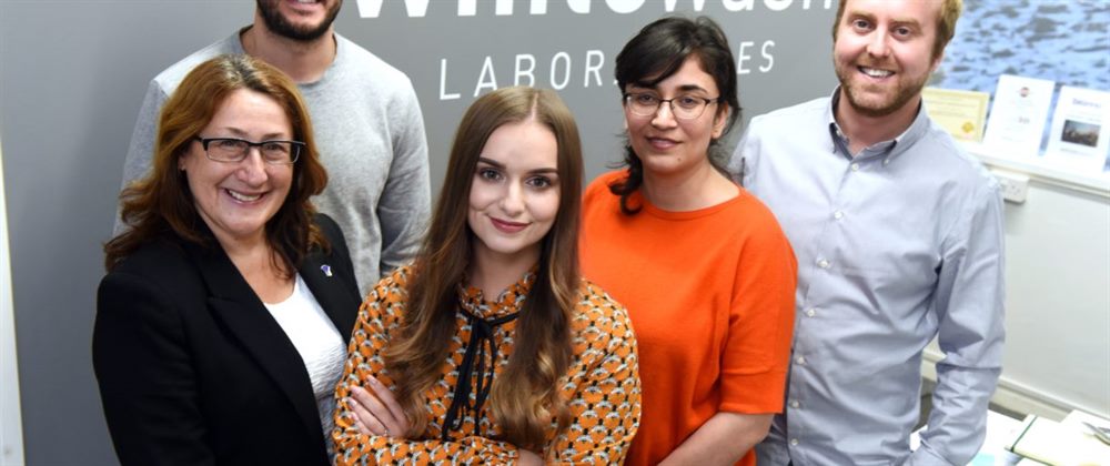A graduate working with a supervisor on a digital marketing project